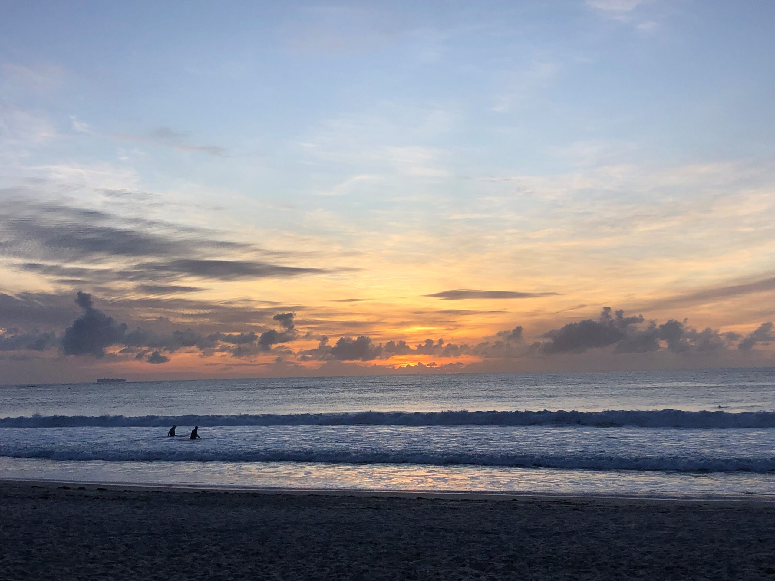 Photo of the day: sunrise surfers