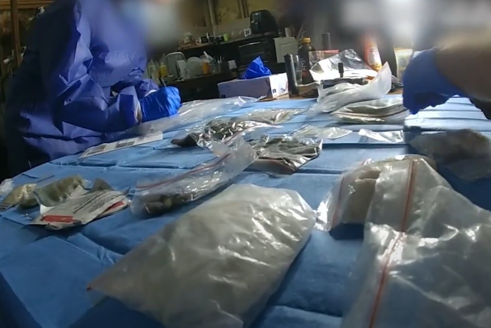 Three arrested after guns, drugs and cash seized