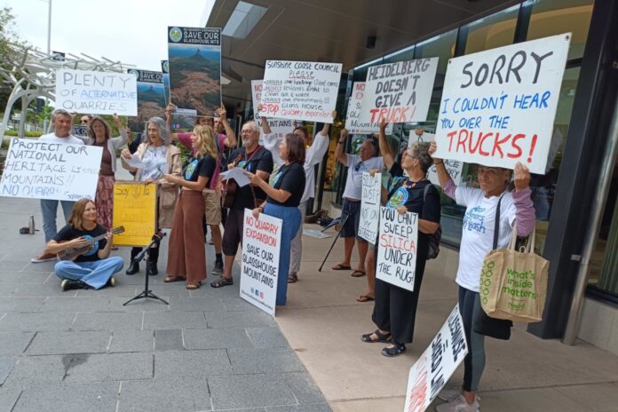 Save Our Glass House Mountains representatives hold placards outside Sunshine Coast City Hall.