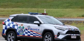 A police car is pictured parked on a road.