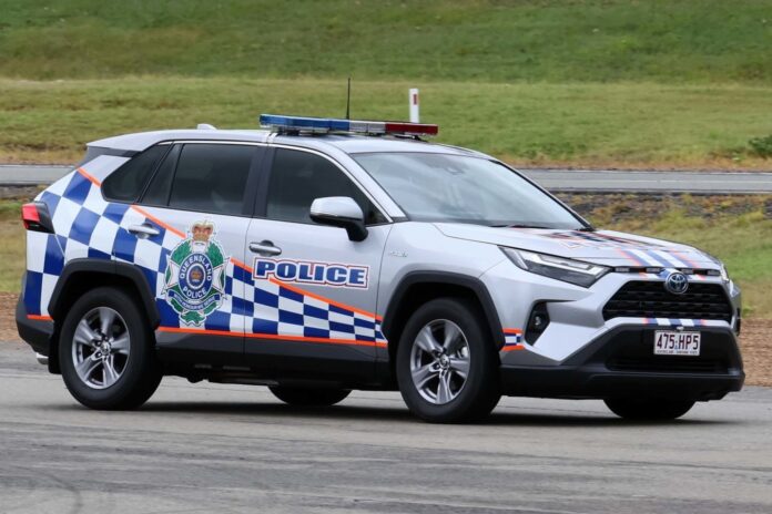 A police car is pictured parked on a road.