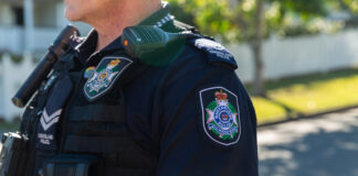 A police officer on a suburban street.