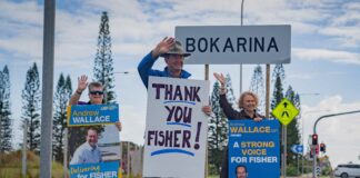 Andrew Wallace and supporters holding signs that say 'Thank You Fisher'.