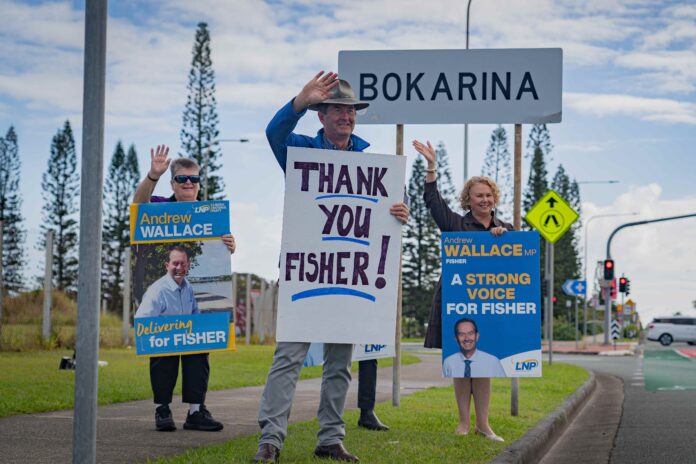 Andrew Wallace and supporters holding signs that say 'Thank You Fisher'.