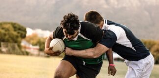 A tackle is made in a footy game. Columnist Ashley Robinson was involved in a few incidents on the field.