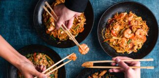People use chopsticks to enjoy Chinese food.