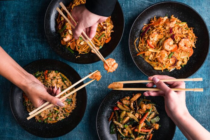 People use chopsticks to enjoy Chinese food.