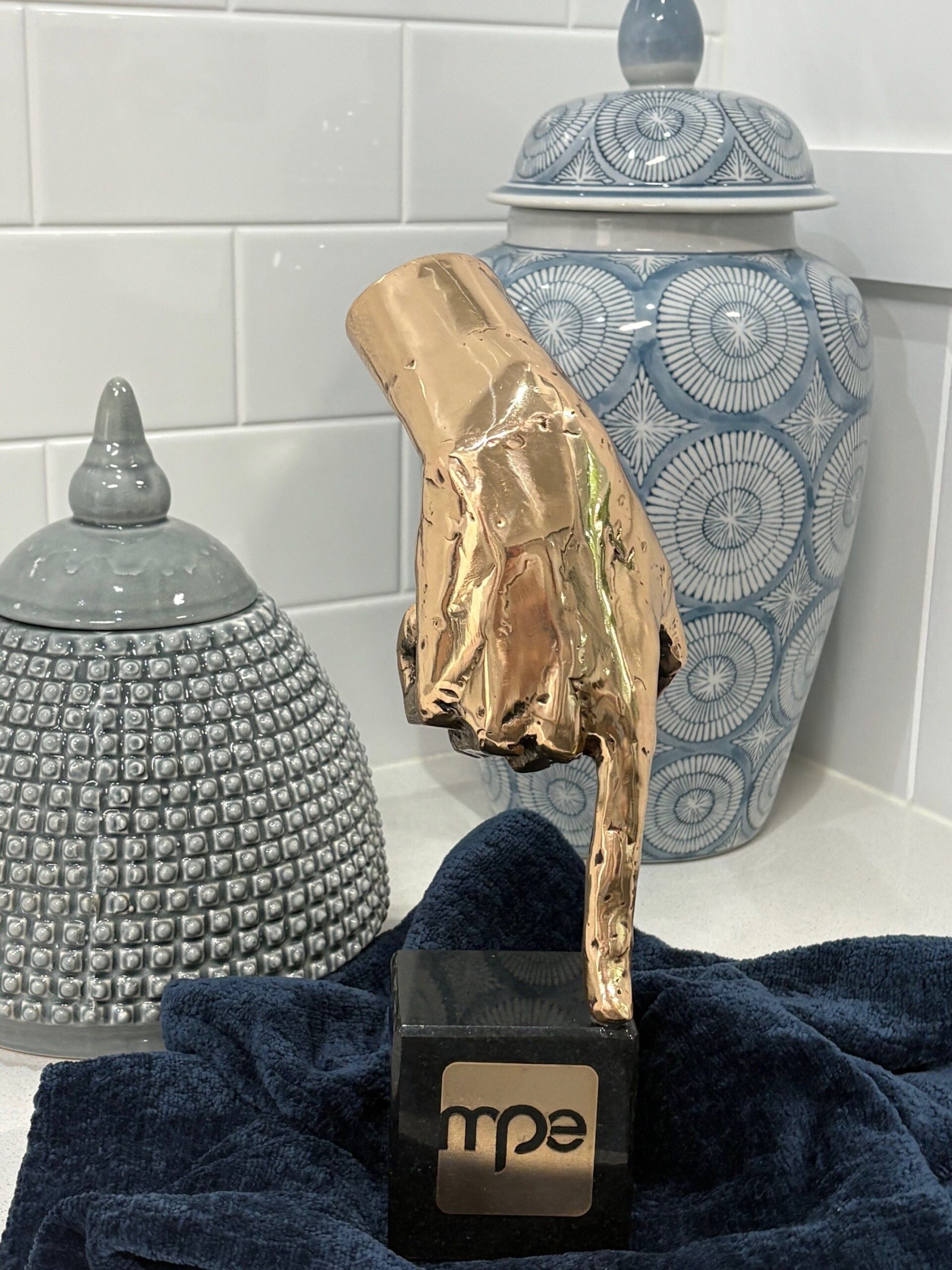 A trophy of a golden hand from the 2025 MPE Awards.