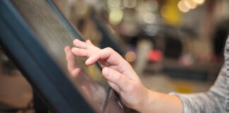 A woman's hand charging a payment.