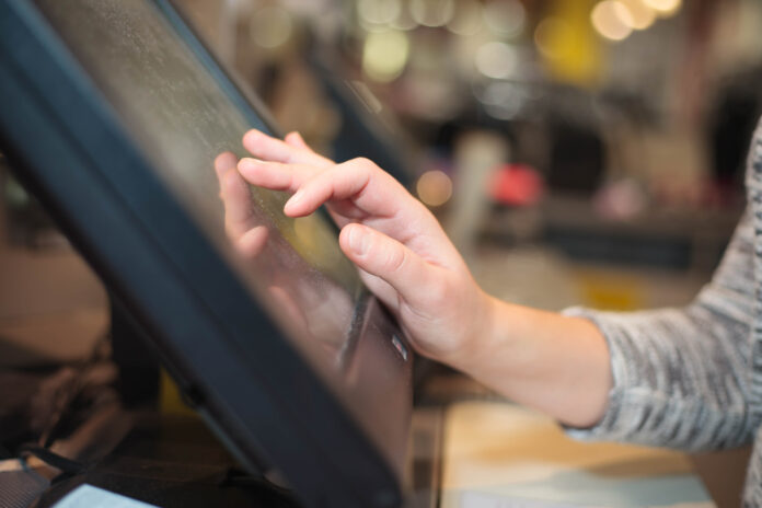 A woman's hand charging a payment.