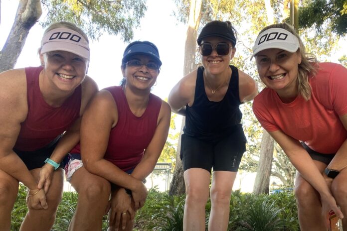 Deb Lazarenko with fellow runners smiling for the camera.