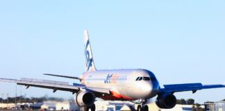 A Jetstar plane landing at Sunshine Coast Airport.