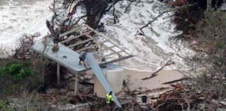 The remnants of the Lions Park shelter are taken away as water laps around it. Picture by Damien Lange, droner.au