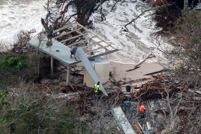 The remnants of the Lions Park shelter are taken away as water laps around it. Picture by Damien Lange, droner.au
