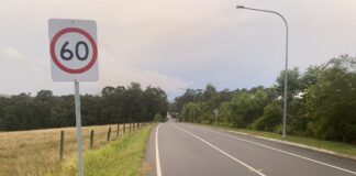 Steggalls Road stretches into the distance, with a 60kmh sign next to it in the foreground.