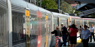 Passengers get on a train at a station in Queensland. Picture by AAP.