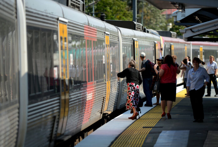 Passengers get on a train at a station in Queensland. Picture by AAP.