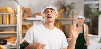 A young baker waves off a work colleague. Picture from Shutterstock.