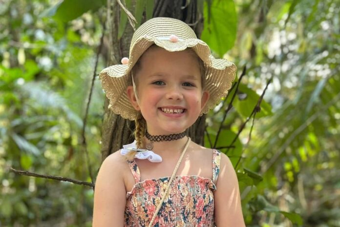 A smiling child wearing a hat.
