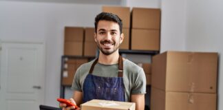 Young man holding boxes.