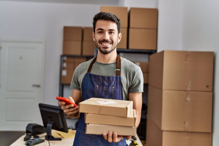 Young man holding boxes.