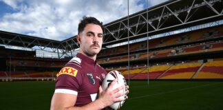 Trent Loiero stands with a football on the field at Suncorp Stadium. Picture by AAP.