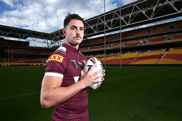 Trent Loiero stands with a football on the field at Suncorp Stadium. Picture by AAP.