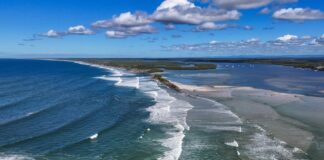 An aerial photo shows waves rolling through the Bribie Island breakthrough, which is more than 1km wide. Picture via Bluey's Photography.
