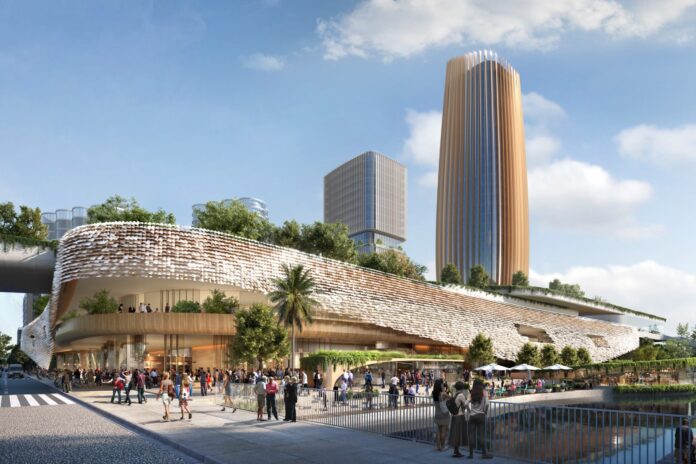 An impression of the sports arena planned for Maroochydore, shows the exterior of a sleek building, a courtyard and towers in the background.