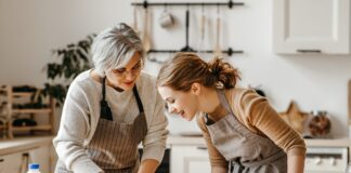 A grandmother and granddaughter knead dough in a kitchen. Picture: Shutterstock.