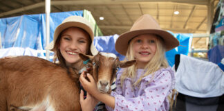 Two young girls pat a goat at a previous edition of the Show. Picture: Greg Gardner/Sunshine Coast Agricultural Show.