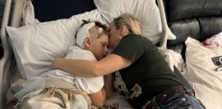 Gaving is embraced by his mother Angela Boldt in a hospital bed after an e-scooter crash. Picture by AAP.