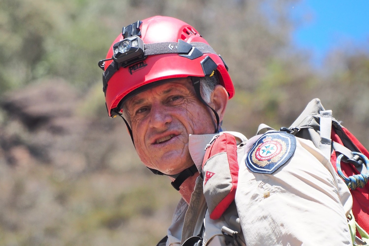 Firefighter Greg Toman looks at the camera while on a job in the mountains.