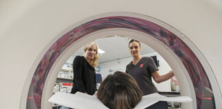 Two radiology staff members watch on as a patient gets an MRI. Sunshine Coast Radiology will be at the Maroochy Private Hospital.