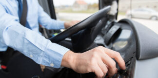 A close up of a bus driver's hands on a steering wheel. Picture: Shutterstock.