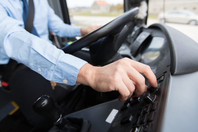A close up of a bus driver's hands on a steering wheel. Picture: Shutterstock.