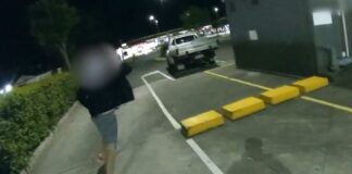 Police pursue a man in a Gympie carpark.