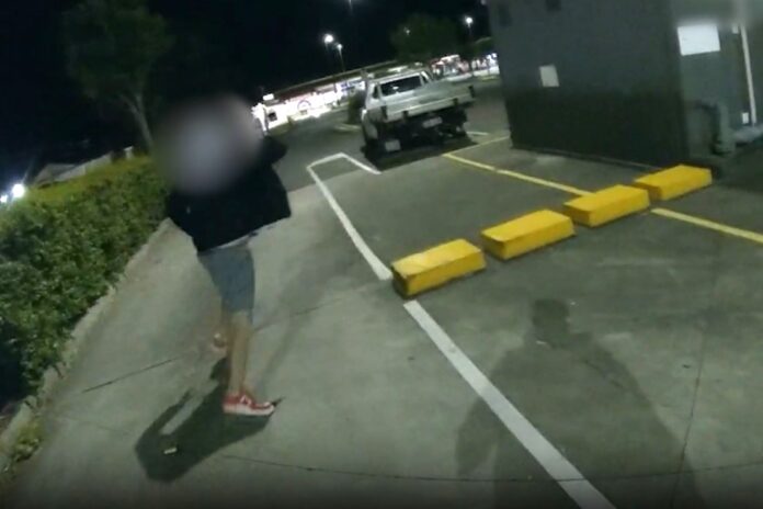 Police pursue a man in a Gympie carpark.