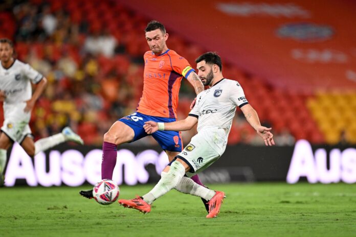 Roar and Mariners players jostle for the ball. Picture: AAP.