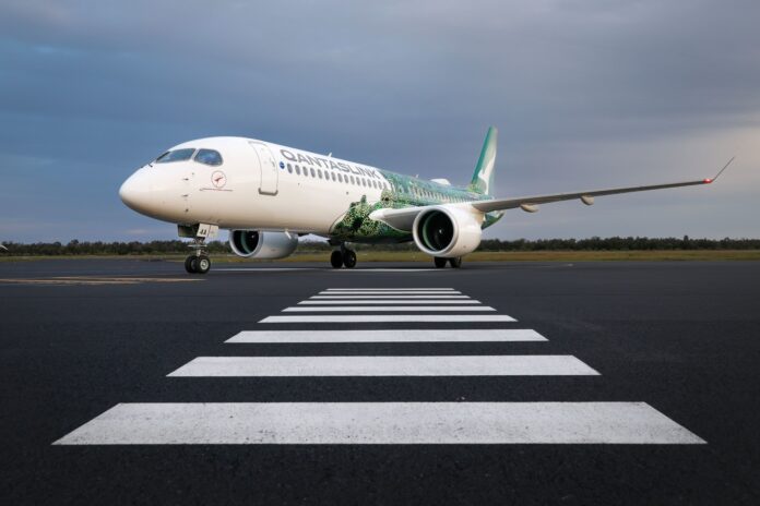 A QantasLink A220 on the runway.