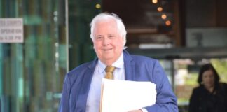 Clive Palmer leaves court in Brisbane on Friday.