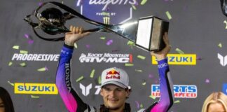 Jettg Lawrence hoists the trophy after winning the SMX World Championship.