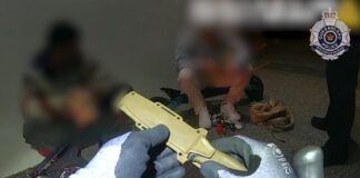 Police seizing a knife.