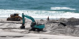 An excavator at work on Bribie Island. Picture: Damien Lange, Droner.au