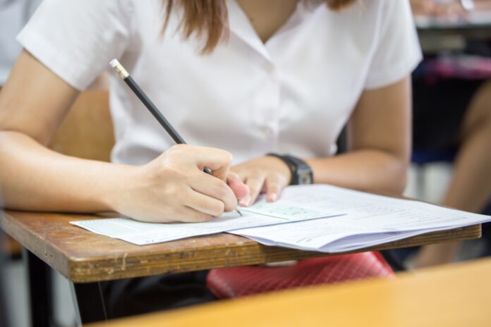 High,School,university,Student,Study.hands,Holding,Pencil,Writing,Paper,Answer,Sheet.sitting A student at a desk. Picture: Shutterstock.
