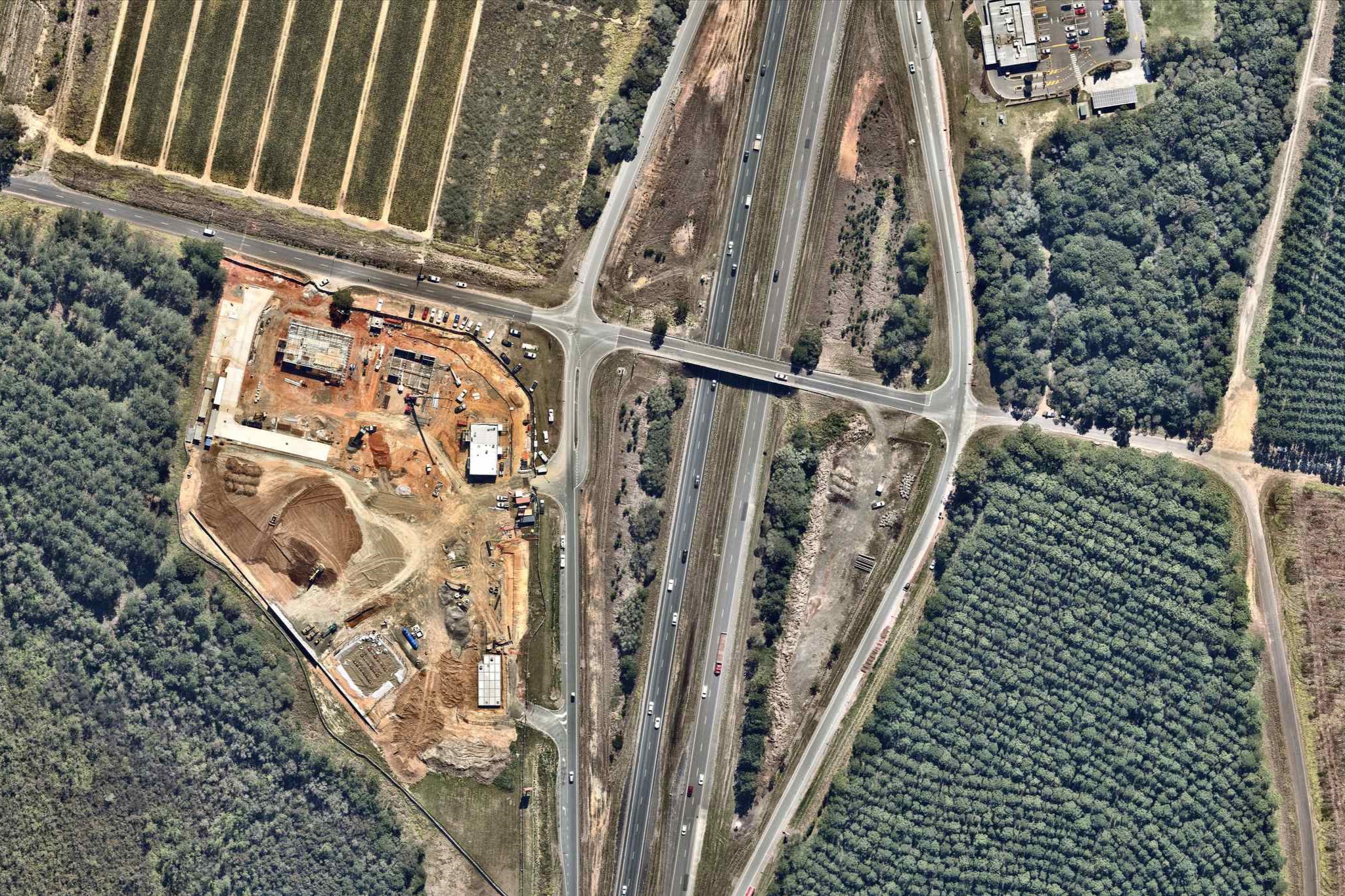 A new service station precinct, with multiple fast food outlets including a GYG, is being built by the highway at Glass House Mountains. Picture: Nearmap.