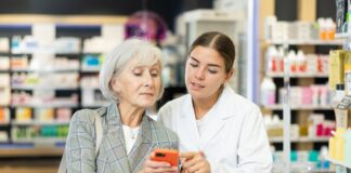 A pharmacy assistant helping a customer.