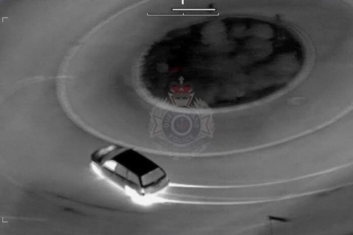 A still from police helicopter footage, of a car.