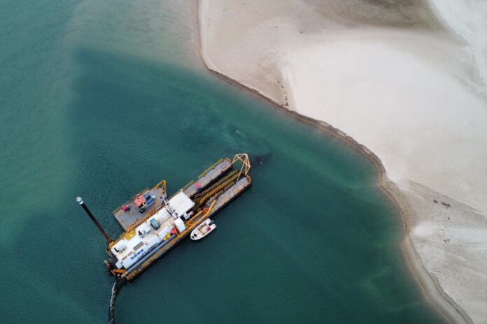 A dredger collects sand from Maroochy River.