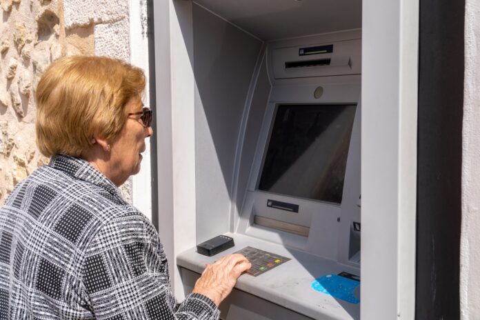 Senior woman using an ATM
